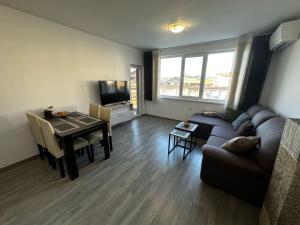 a living room with a couch and a table at Apartment Aria 6 in Velingrad