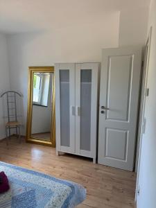 a room with a mirror and a door and a rug at Three-castle-view in a new appartment in Neckarsteinach