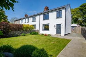 a white house with a lawn in front of it at The Bank House in Silverdale