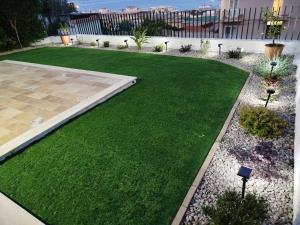 a garden with green grass and a pathway at Il Giardino sul Golfo in Gaeta