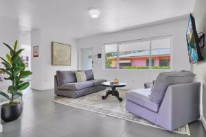 a living room with two chairs and a table at 175 Casa Buena Blanca in Miami