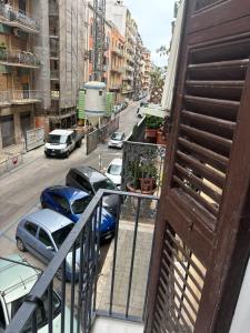 a balcony with cars parked on a city street at i girasoli appartament s in Bari