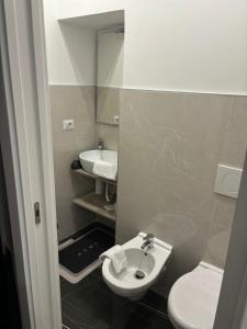 a small bathroom with a sink and a toilet at i girasoli appartament s in Bari