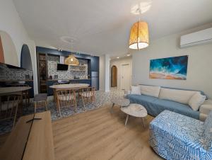 a living room with a couch and a table at Solea Suites in Chernomorets