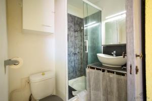 a bathroom with a toilet and a sink at Studio Yellow Mood - Pond, Beach, Peace & Parking in Le Barcarès