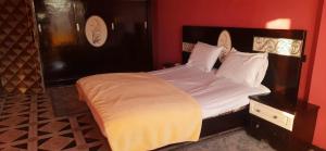 a bedroom with a large bed with white sheets at Downtown Apartment in Aswan