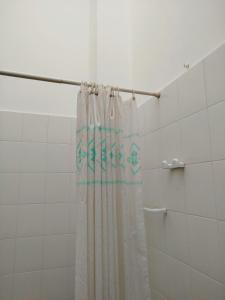 a shower curtain is hanging in a bathroom at MarGaMik Holiday in Aradeo +22 photos