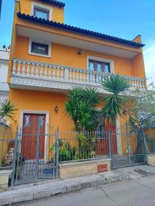 a orange house with a fence in front of it at MarGaMik Holiday in Aradeo +22 photos