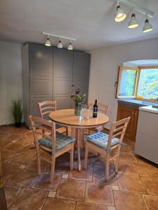 a kitchen with a wooden table and chairs and a table at Beli Casa in Beli