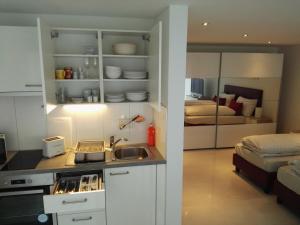 a kitchen with a sink and a bed in a room at Sunrise Apartment in Staad
