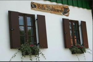 a building with two windows and a sign on it at Weineks Kellerstöckl - Waldesruh in Kulm im Burgenland