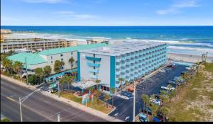 an aerial view of a hotel and the beach at Beach Condo with Pool & Tiki Bar! in Daytona Beach