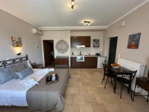 a bedroom with a bed and a table and a kitchen at Iremia in Kariá