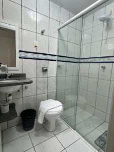 a bathroom with a shower and a toilet and a sink at Big Hotel Florianópolis in Florianópolis