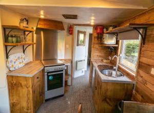 a small kitchen with a sink and a stove at Ramshaw View in Leek