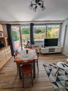 a living room with a table and a television at Charmant studio proche plage in Roquebrune-Cap-Martin