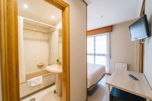 a bathroom with a bed and a sink and a toilet at Miracielos in Barro de Llanes +37 photos