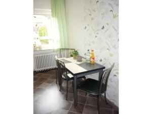 a dining room with a table and chairs and a window at Family Sesterheim Comfortable holiday residence in Niederehe