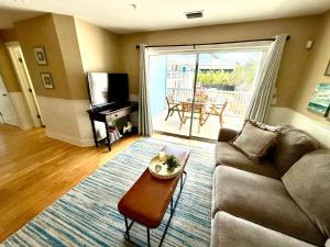 a living room with a couch and a table at Tybee Retreat Unit 1 in Tybee Island