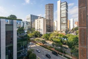 a view of a city street with tall buildings at Housi Faria Lima in Sao Paulo