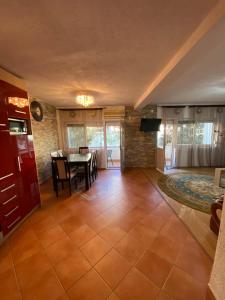 a living room with a table and a dining room at Centerside Apartment in Ulcinj