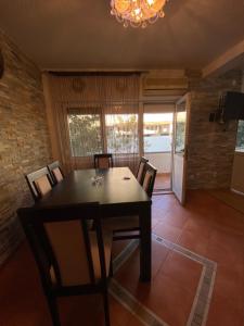 a dining room with a black table and chairs at Centerside Apartment in Ulcinj +4 photos
