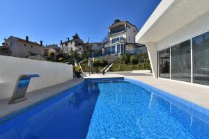 a swimming pool in front of a house at House Luxury in Matulji +35 photos