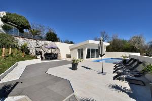 a house with a patio and a swimming pool at House Luxury in Matulji