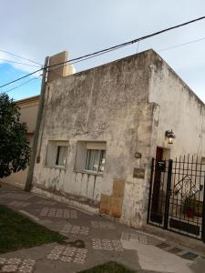 an old building with a gate in front of it at Lo de pedro in Carhué