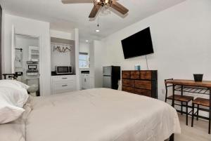 a bedroom with a white bed and a ceiling fan at Blue Mist Motel - Room #4 in Daytona Beach