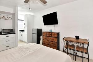 a bedroom with a bed and a desk and a tv at Blue Mist Motel - Room #4 in Daytona Beach