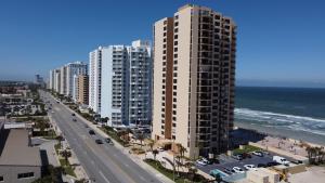 a view of a beach with tall buildings and the ocean at Blue Mist Motel - Room #8 in Daytona Beach