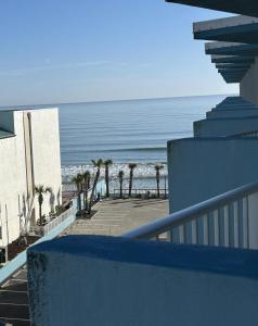 a view of the beach from the balcony of a building at Beach Condo with Pool & Tiki Bar! in Daytona Beach