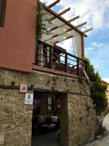 a building with a balcony on top of it at Varosi Guesthouse in Edessa