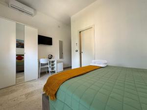 a bedroom with a large bed and a table at Casa Duca D'aosta in Venice