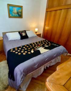 a bedroom with a bed with a black and white blanket at Lindo Departamento Centro in Osorno