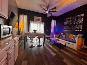 a living room with a table and a couch at Mid-Town View 4 BR Near NYC in Union City