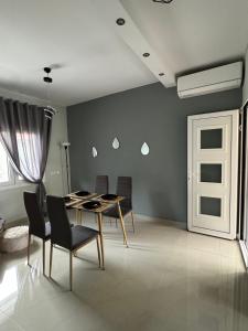 a dining room with a table and chairs at Mountain & Sea Escape in Leptokarya +8 photos