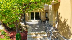 a walkway leading to a building with a tree at Nr 25 Ferienhaus Astor in Keszthely +48 photos