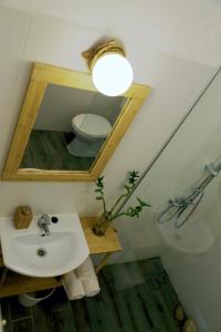a bathroom with a sink and a mirror and a toilet at Guest house Mediterranea in Pakoštane