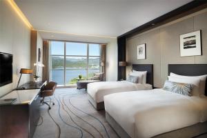 Postel nebo postele na pokoji v ubytování Sunrise Kempinski Hotel Beijing