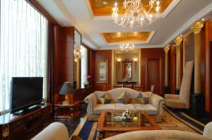 a living room with a couch and a television at Kempinski Hotel Shenzhen in Shenzhen