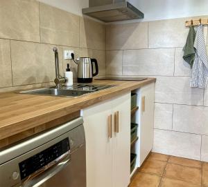 a kitchen with a sink and a stove at Sol Cinco in Arelho