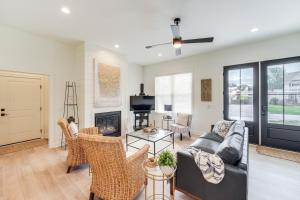 a living room with a couch and a fireplace at Walk to Lake Erie Sleek Retreat with Screened Patio in Madison