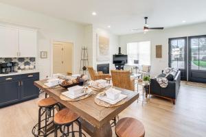 a kitchen and living room with a table and chairs at Walk to Lake Erie Sleek Retreat with Screened Patio in Madison