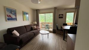 a living room with a couch and a table at Refuge des Vues Alpines Isola 2000 in Isola 2000