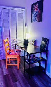 a desk with a laptop and a chair in a room at Iron Bound Gem in Newark +20 photos