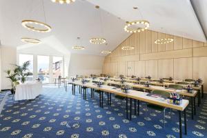 a large dining room with tables and chairs at Hotel Bayerischer Hof in Lindau +31 photos