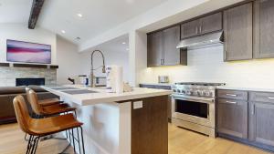 a kitchen with wooden cabinets and a counter top at Cozy Cabin for 8 Close to Eagle Lodge in Mammoth Lakes