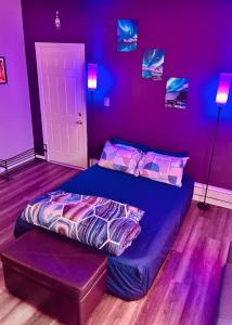 a purple bedroom with a large bed in a room at Iron Bound Gem in Newark